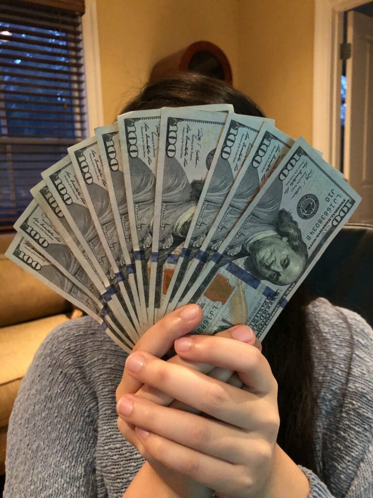 Girl Holding 00 bills